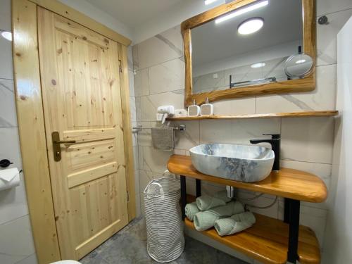 a bathroom with a sink and a mirror at Princess Mojca Holiday House in Bled