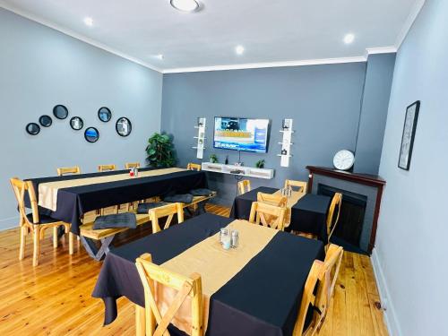 a restaurant with tables and chairs in a room at Alberta Bed and Breakfast in Pietermaritzburg