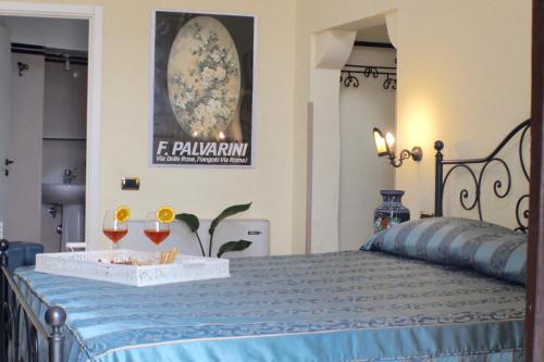 a bedroom with a bed with a tray of drinks on it at Palazzo Senape De Pace in Gallipoli