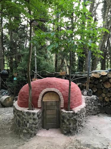 a large red building with a door in the middle at Mindfulness Glamping, Retiro de Yoga, Todo Incluido in Mexico City