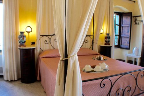 a bedroom with a bed with a plate of food on it at Palazzo Senape De Pace in Gallipoli