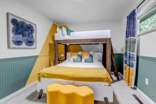 a bedroom with a bed with yellow and green walls at Mountain Views Climbing wall Mini Golf Hot tub in Colorado Springs