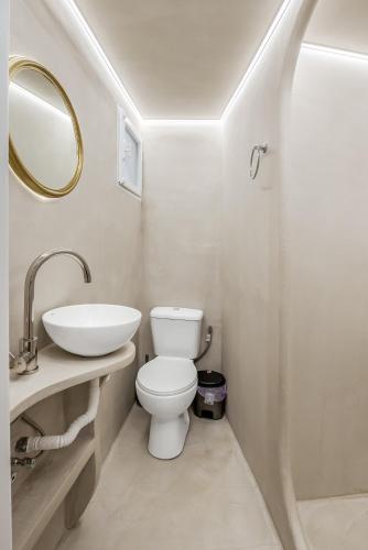 a bathroom with a white toilet and a sink at Vincenzo Harmony II- Rethymno old town in Rethymno Town