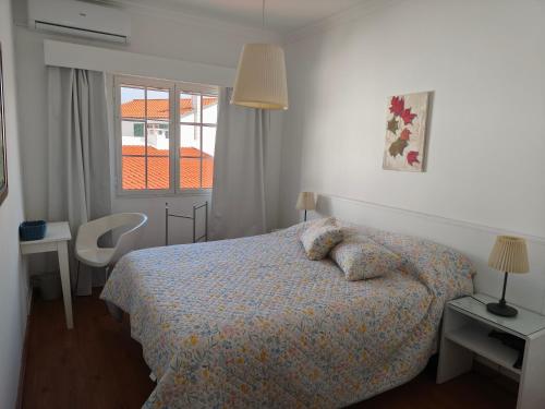 a bedroom with a bed and a window at Gorgeous House in Ponta Delgada