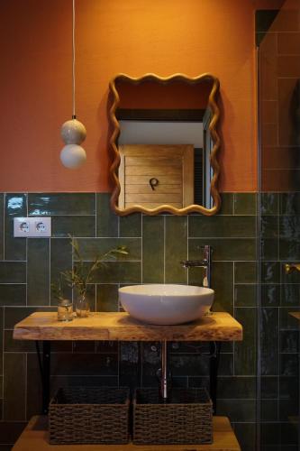 a bathroom with a sink and a mirror at Hotel Finca Olivar in Benissa