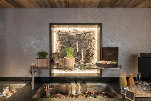 a kitchen with a sink with a window above it at BRUGGER ApartHotel in Mayrhofen