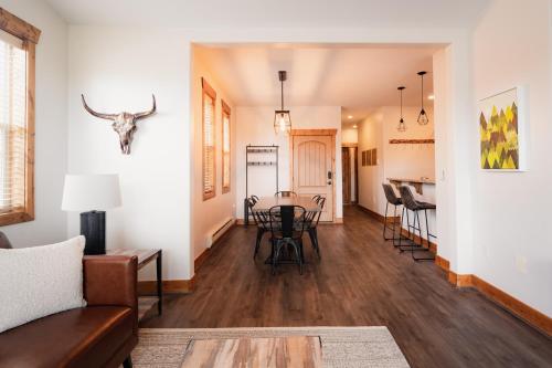 a living room with a couch and a table at Large & Updated Driggs Condo Close to Town! 40 miles to Grand Teton! in Driggs