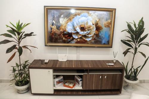 a painting of a flower is hanging on a wall at Gabon Happiness House in Libreville