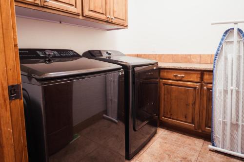 a kitchen with a black stove and a sink at Large & Updated Driggs Condo Close to Town! 40 miles to Grand Teton! in Driggs