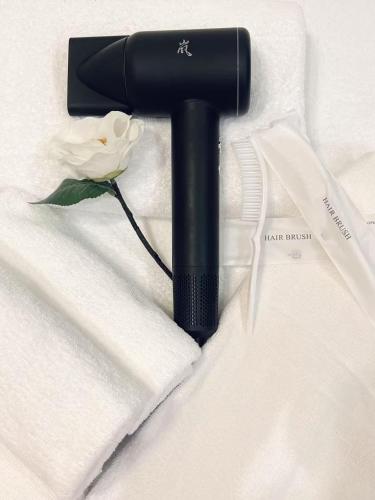 a black object with a flower on a white shirt at Hotel Arashi Shinsaibashi No001 in Osaka