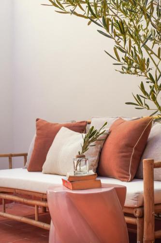 a living room with a couch with pillows at Hotel Finca Olivar in Benissa