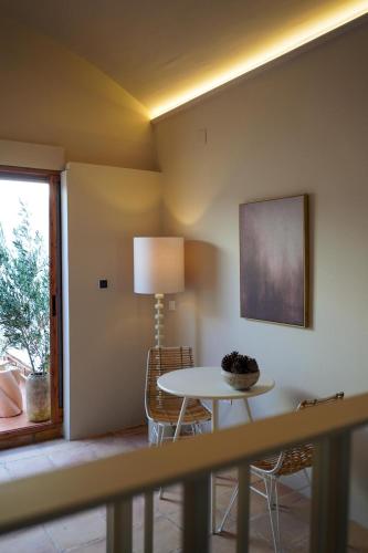 a room with a table and chairs and a window at Hotel Finca Olivar in Benissa
