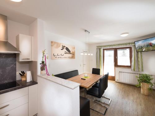 a kitchen and dining room with a table and chairs at Haus Rainer in Mühlbach am Hochkönig
