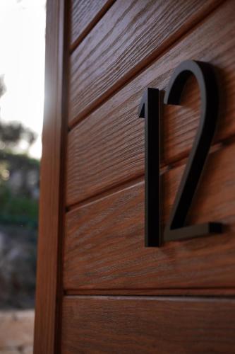 a wooden door with the number on it at Hotel Finca Olivar in Benissa