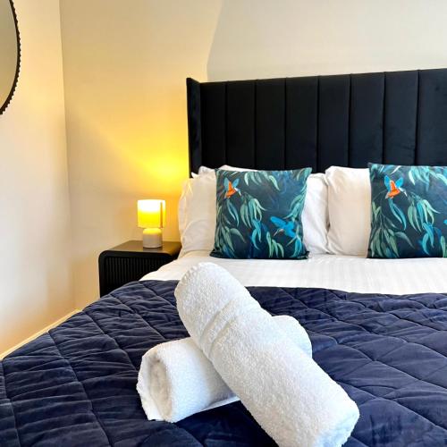 a bedroom with a bed with two towels on it at City Centre House - Pet Friendly - Free Parking - 2 Bedroom - Large Garden in Cardiff