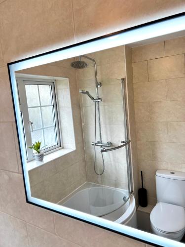 a bathroom with a shower and a tub and a toilet at City Centre House - Pet Friendly - Free Parking - 2 Bedroom - Large Garden in Cardiff