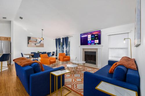 a living room with two blue couches and a fireplace at Family friendly - Fire pit -4 min to UF - Spacious in Gainesville