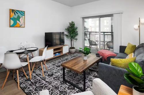 a living room with a couch and a table at Urban Retreat - Free Parking, WiFi, Walk to Stadium in Charlotte