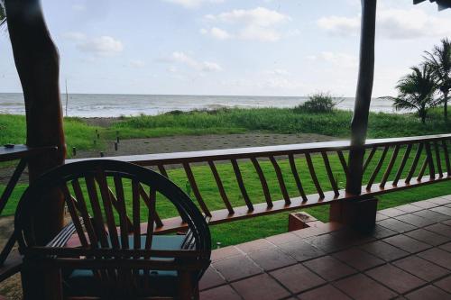 a bench sitting on a porch looking at the ocean at Casa Marea in Cambutal