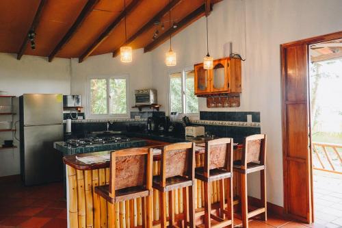 a kitchen with a counter and some chairs in it at Casa Marea in Cambutal