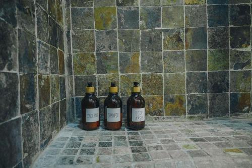 three bottles of wine sitting on a tiled wall at Casa Marea in Cambutal