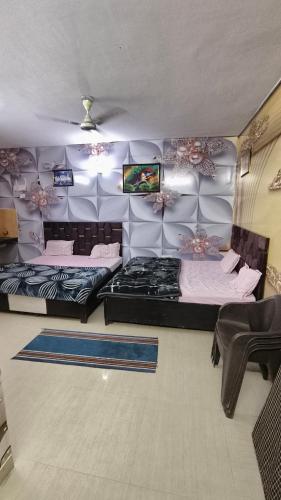 a room with two beds and a table and chairs at Omaxe Eternity-Near Prem Mandir in Vrindāvan