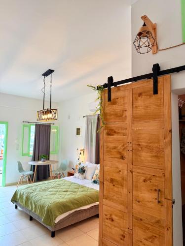 a bedroom with a bed and a large wooden door at Marine's apartments in Symi
