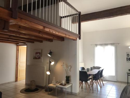 a living room with a staircase and a table at Maison de vacances Olonzac in Olonzac