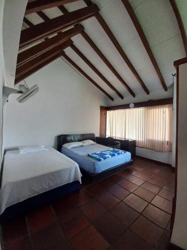 a room with two beds and a couch in it at El Linaje Home in Cali