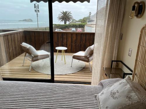 a bedroom with a balcony with a view of the ocean at Hotel Pacífico in Matanzas