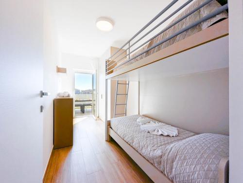 a bedroom with a bunk bed with a ladder at Appartamenti Pamar in Civitanova Marche