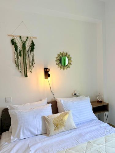a bedroom with a bed with white sheets and pillows at Marine's apartments in Symi