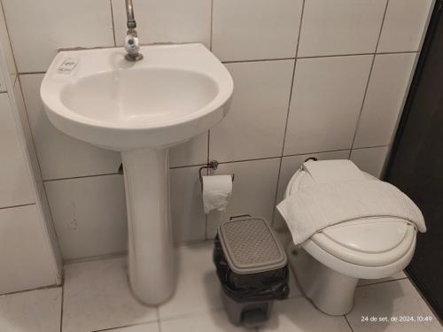 a bathroom with a sink and a toilet at Hotel Santa Catarina in Santos