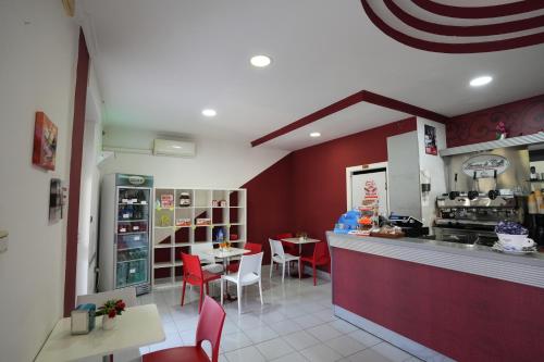 a restaurant with red walls and a table and chairs at Hotel Riggioni in Pozzilli