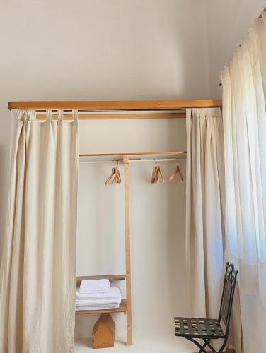 a bunk bed with a chair and a window at Vergel San Pedro in Torremenga