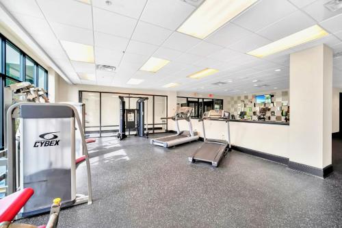 a gym with treadmills and machines in a building at 2BR Condo with Hot tub and pool, near Disney! in Orlando