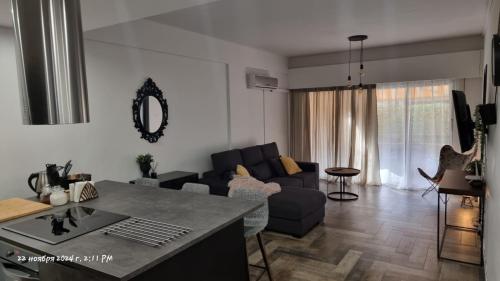 a living room with a couch and a table at Deana beach in Limassol