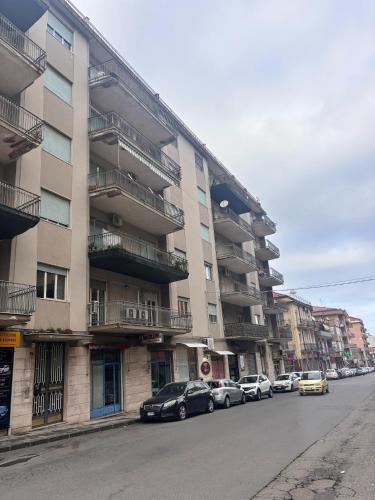 a row of cars parked in front of an apartment building at Appartamento turistico Giarre in Giarre