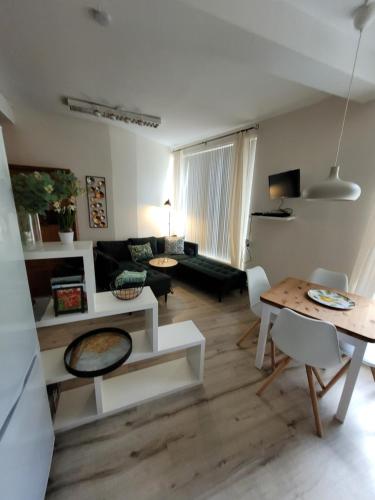 a living room with a couch and a table at Het Mergelhoek 1 - Parterre in Vaals