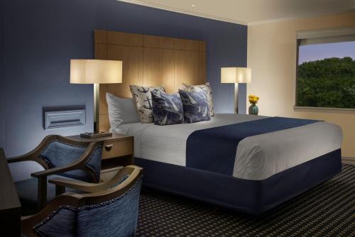 a hotel room with a large bed and a window at Ocean Street Inn in Hyannis