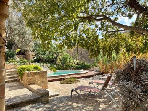 a yard with a chair and a swimming pool at Asis de Marratxinet Turismo de Interior in Marratxí 