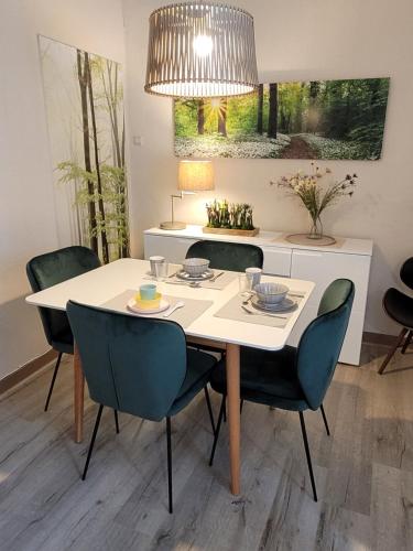 a dining room with a white table and chairs at Het Mergelhoek 1 - Parterre in Vaals