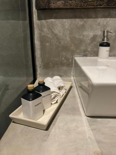 a bathroom with two bottles of soap and a sink at Stonewater Beach Villa, Negombo in Mahawatta