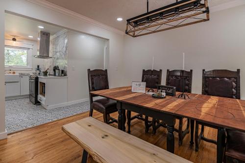 a kitchen and dining room with a wooden table and chairs at Southern Pines Gem with 2 Master-King Suites in Southern Pines