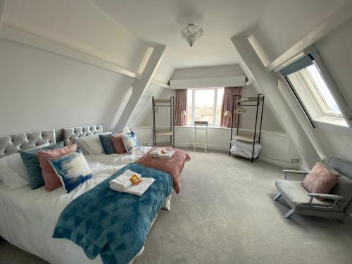 a bedroom with a bed and a chair in it at Blue Ocean Seaview Penthouse Perfectly Saltburn in Saltburn-by-the-Sea