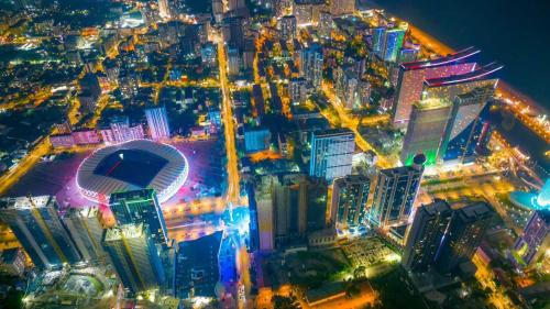 an aerial view of a city at night at Beautiful apartments near the sea - ORBI CITY N7 in Batumi