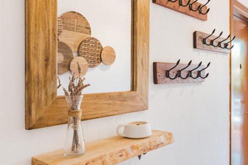 a mirror on a wall with a vase on a shelf at Villa Lucia in Alghero