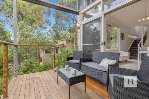 a screened in porch with chairs and a table at Murrays Lakeshore Getaway in Murrays Beach