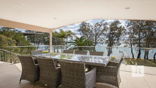 a dining room with a table and chairs at Enjoy Lazy Daze in Summerland Point