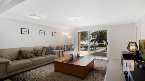 a living room with a couch and a coffee table at Enjoy Lazy Daze in Summerland Point